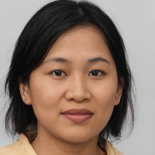 Joyful asian young-adult female with medium  brown hair and brown eyes