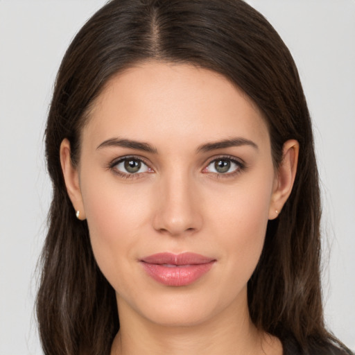 Joyful white young-adult female with long  brown hair and brown eyes