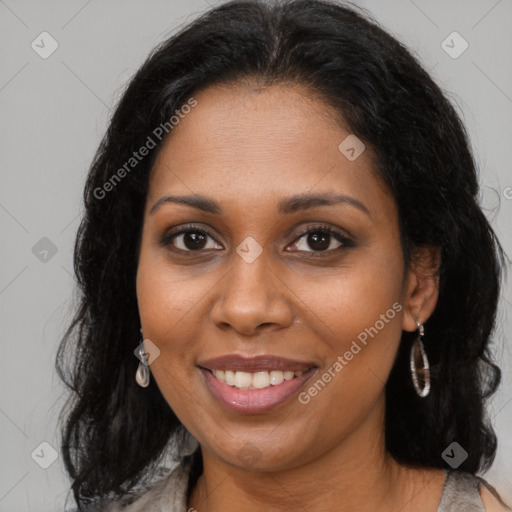 Joyful black young-adult female with long  brown hair and brown eyes