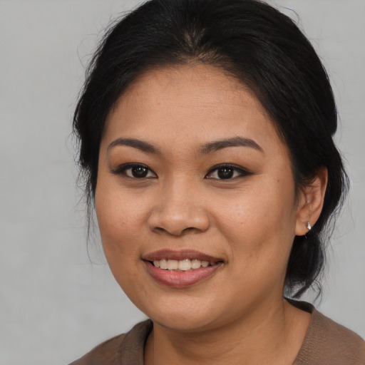 Joyful asian young-adult female with medium  black hair and brown eyes
