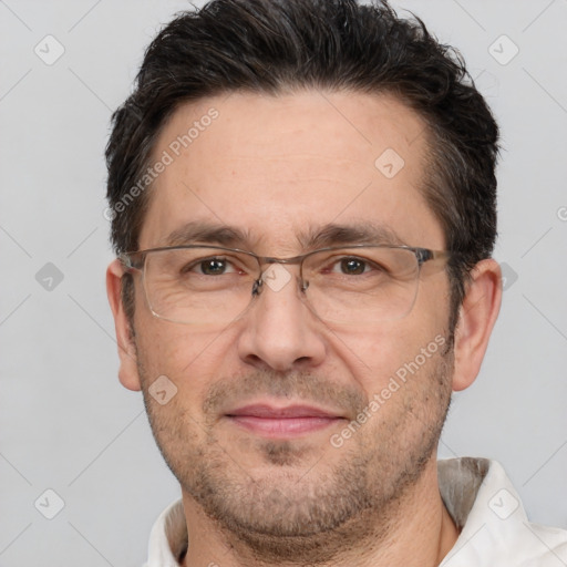 Joyful white adult male with short  brown hair and brown eyes