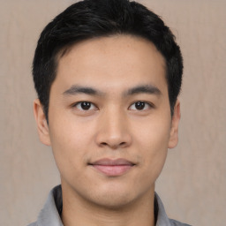 Joyful asian young-adult male with short  black hair and brown eyes