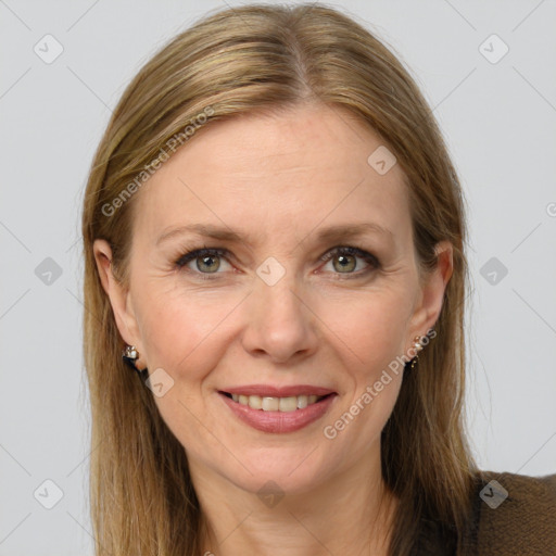 Joyful white adult female with long  brown hair and grey eyes