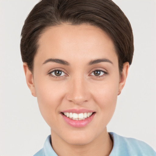 Joyful white young-adult female with short  brown hair and brown eyes