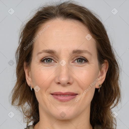 Joyful white adult female with medium  brown hair and grey eyes