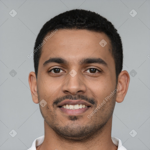 Joyful latino young-adult male with short  black hair and brown eyes