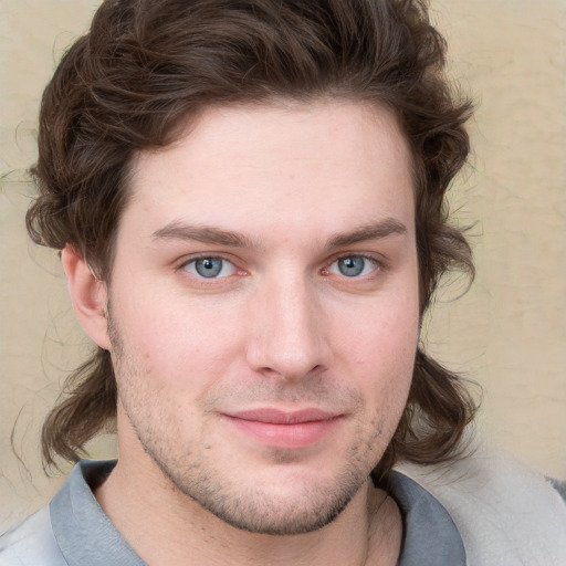 Joyful white young-adult male with short  brown hair and blue eyes