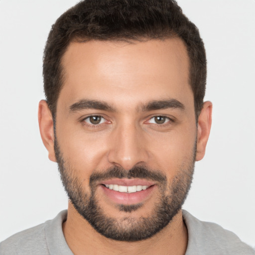 Joyful white young-adult male with short  brown hair and brown eyes