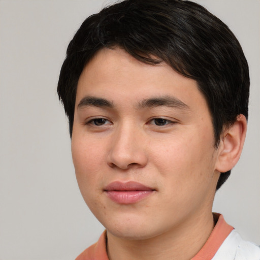 Joyful asian young-adult male with short  brown hair and brown eyes