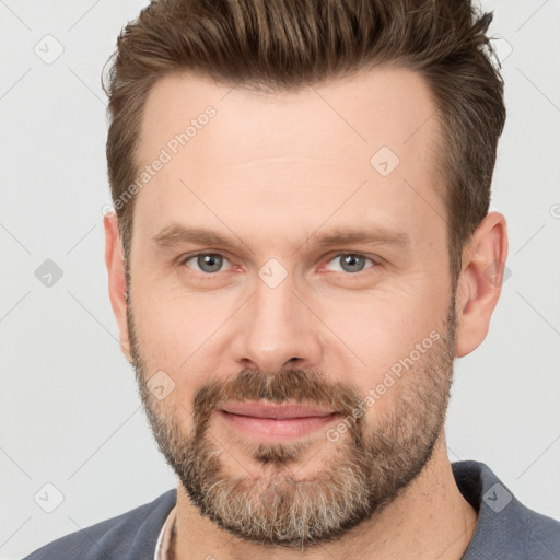 Joyful white adult male with short  brown hair and brown eyes