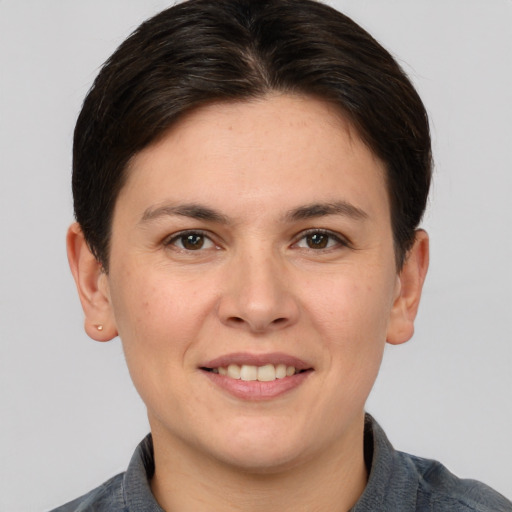 Joyful white young-adult female with medium  brown hair and brown eyes