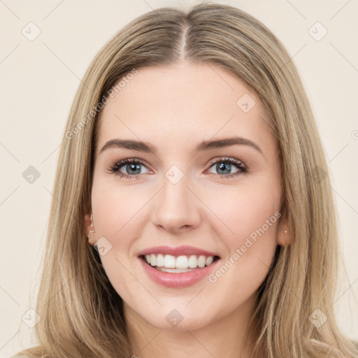 Joyful white young-adult female with long  brown hair and green eyes