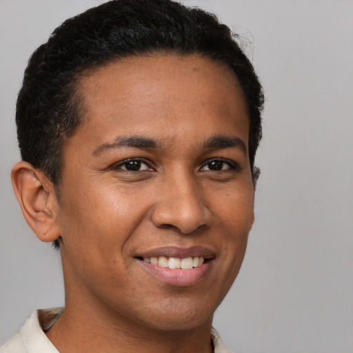 Joyful latino young-adult male with short  brown hair and brown eyes