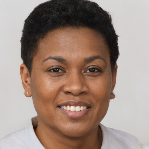 Joyful black young-adult female with short  brown hair and brown eyes