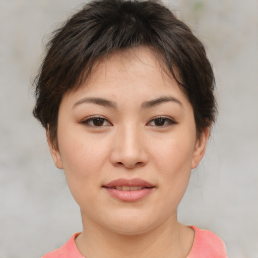 Joyful asian young-adult female with short  brown hair and brown eyes