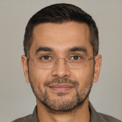 Joyful white adult male with short  black hair and brown eyes