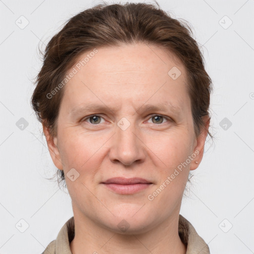 Joyful white adult female with long  brown hair and grey eyes