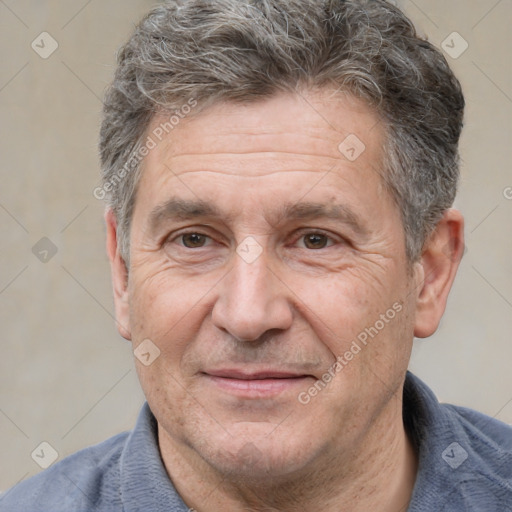 Joyful white middle-aged male with short  brown hair and brown eyes