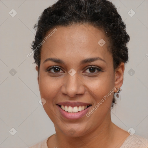 Joyful black young-adult female with short  brown hair and brown eyes