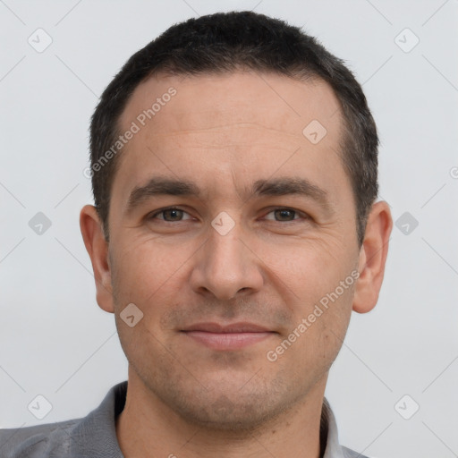 Joyful white young-adult male with short  black hair and brown eyes