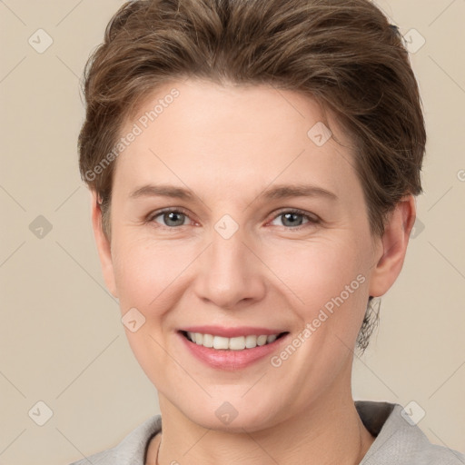 Joyful white young-adult female with short  brown hair and grey eyes