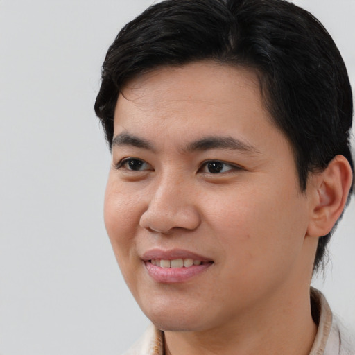 Joyful asian young-adult male with short  brown hair and brown eyes