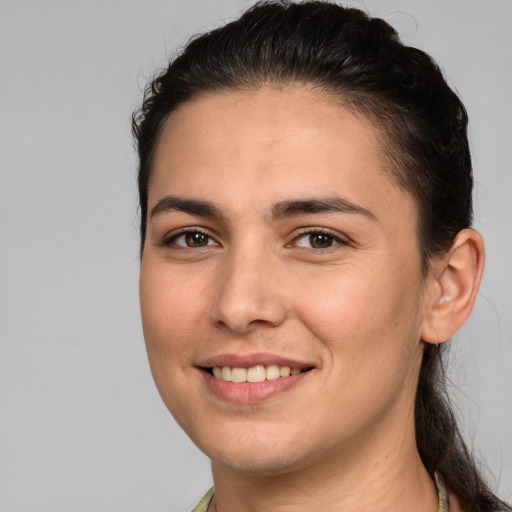 Joyful white young-adult female with long  brown hair and brown eyes