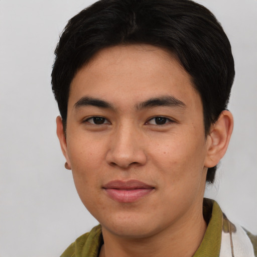 Joyful asian young-adult male with short  brown hair and brown eyes