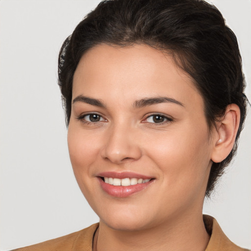 Joyful white young-adult female with short  brown hair and brown eyes