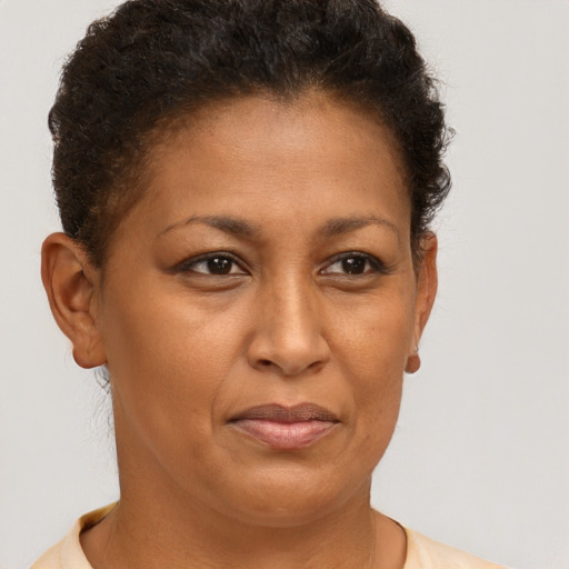 Joyful latino adult female with short  brown hair and brown eyes