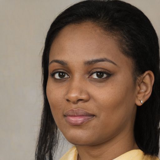 Joyful black young-adult female with medium  black hair and brown eyes