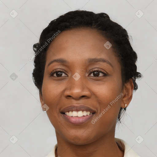 Joyful black young-adult female with short  black hair and brown eyes