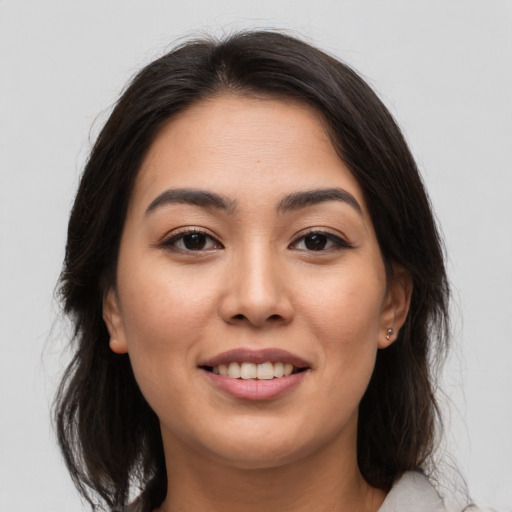 Joyful asian young-adult female with medium  brown hair and brown eyes