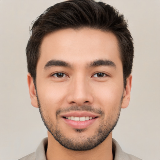 Joyful white young-adult male with short  brown hair and brown eyes