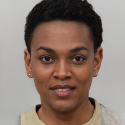 Joyful black young-adult female with short  black hair and brown eyes