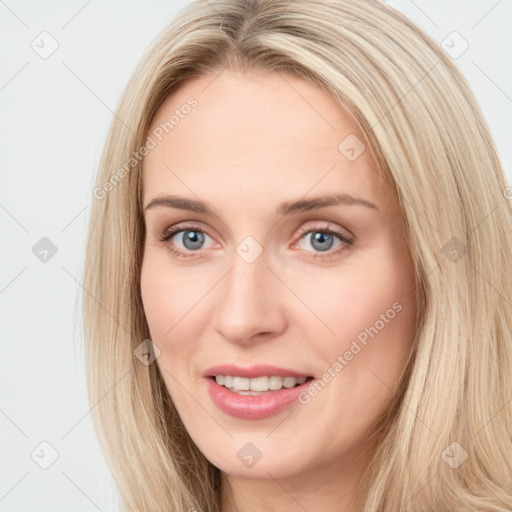 Joyful white young-adult female with long  brown hair and blue eyes