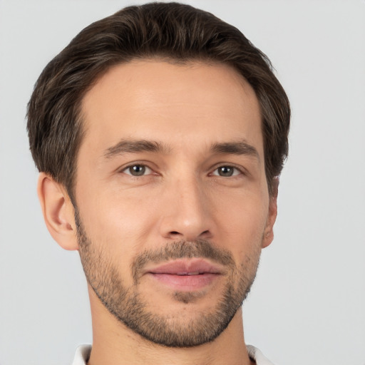 Joyful white young-adult male with short  brown hair and brown eyes