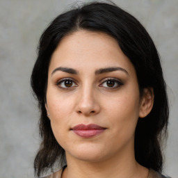 Joyful latino young-adult female with medium  brown hair and brown eyes