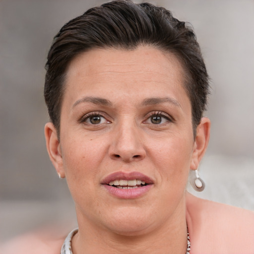 Joyful white adult female with short  brown hair and brown eyes