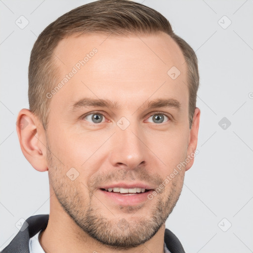 Joyful white young-adult male with short  brown hair and grey eyes