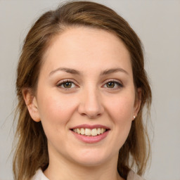 Joyful white young-adult female with medium  brown hair and green eyes