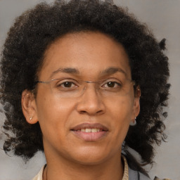 Joyful black adult female with short  brown hair and brown eyes