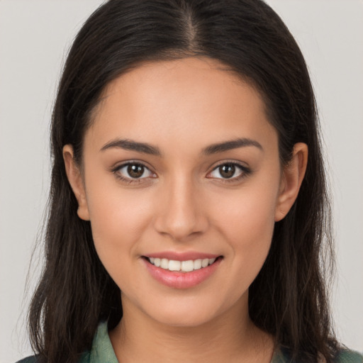 Joyful white young-adult female with long  brown hair and brown eyes