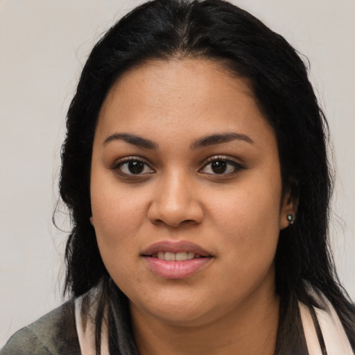 Joyful latino young-adult female with long  black hair and brown eyes