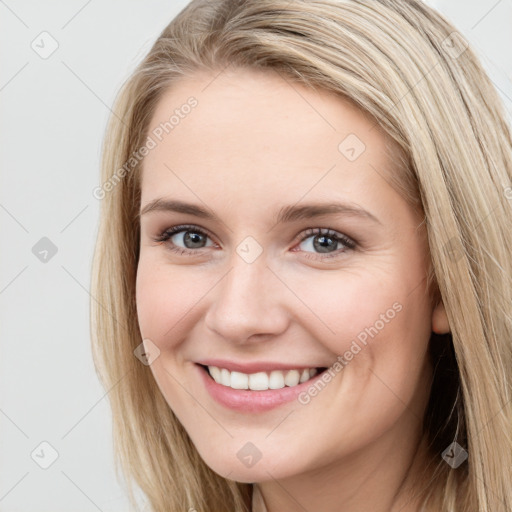 Joyful white young-adult female with long  brown hair and blue eyes