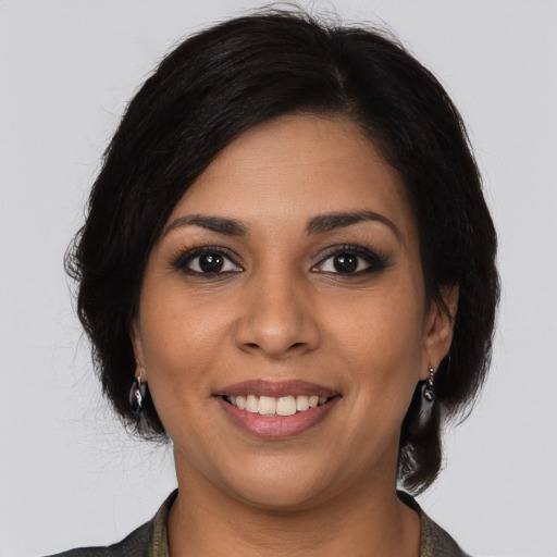 Joyful latino young-adult female with medium  brown hair and brown eyes