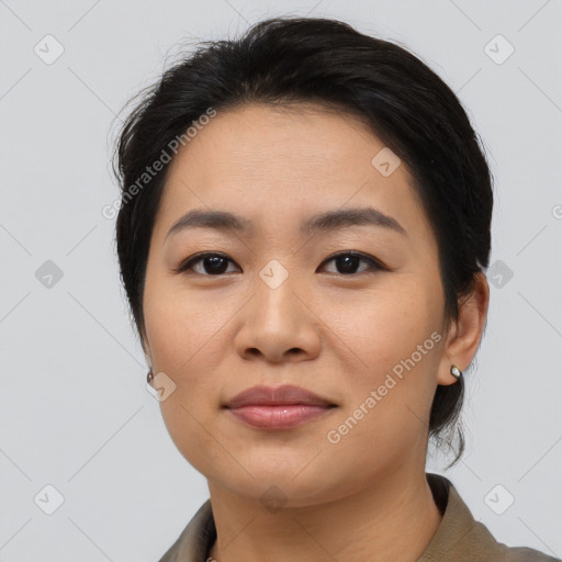 Joyful asian young-adult female with short  brown hair and brown eyes