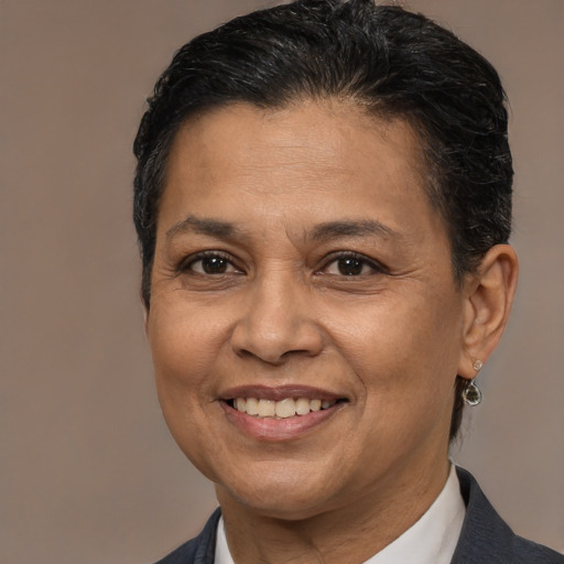 Joyful latino adult female with short  brown hair and brown eyes