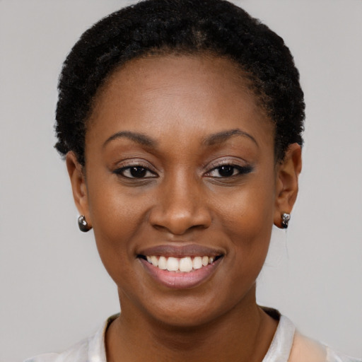 Joyful black young-adult female with short  brown hair and brown eyes