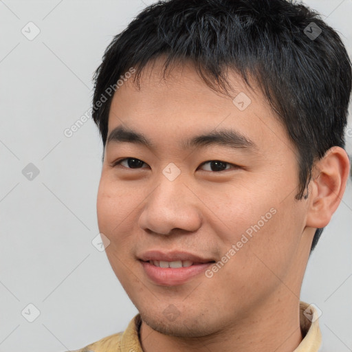 Joyful asian young-adult male with short  brown hair and brown eyes